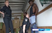 Black suspect gets a naughty surprise with these horny MILFs on duty.