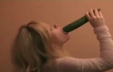 Horny blonde playing with a cucumber